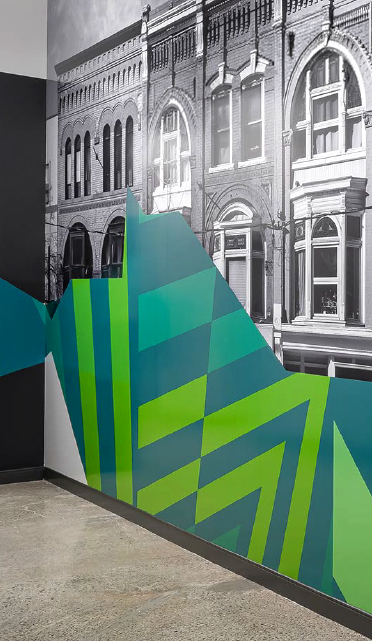 A vibrant display featuring fresh produce, including cabbage, tomatoes, and a dessert with berries, enhancing a storefront's appeal.